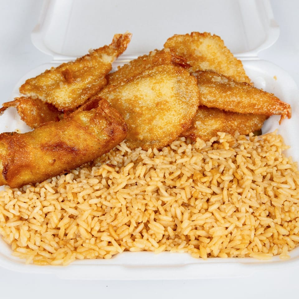 Kung Fu Wings' fried shrimp, egg roll, and fried rice in a white takeout container.